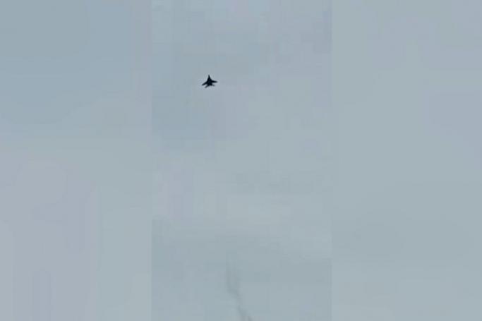 Image of a jet believed to be from Myanmar, involved in clashes with anti-coup fighters, seen flying over Phop Phra district in Thailand's northwestern Tak province. AFP video screenshot