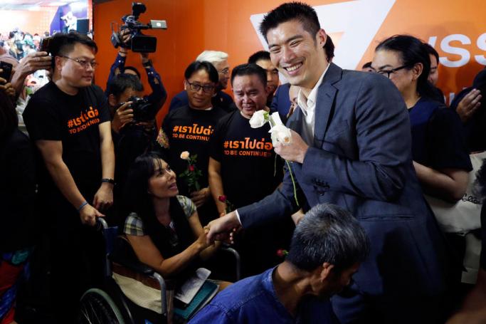 Thanathorn Juangroongruangkit (R), leader of Future Forward Party, receives encouragement from his supporters after the Thai Constitutional Court ruling regarding a rule violation, at the Future Forward headquarters in Bangkok, Thailand, 21 February 2020. Photo: Rungroj Yongrit/EPA