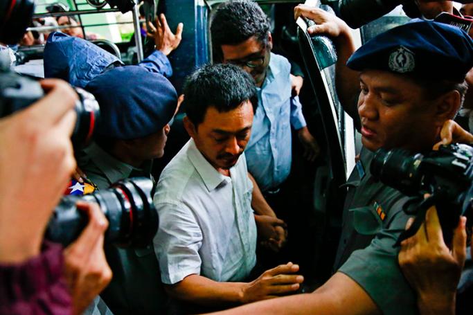 Kyaw Min Swe (C), editor-in-chief of The Voice Daily newspaper, followed by columnist Kyaw Swa Naing (C-R) arrive at the Bahan township court during their first trial in Yangon, Myanmar, 08 June 2017. Photo: Lynn Bo Bo/EPA
