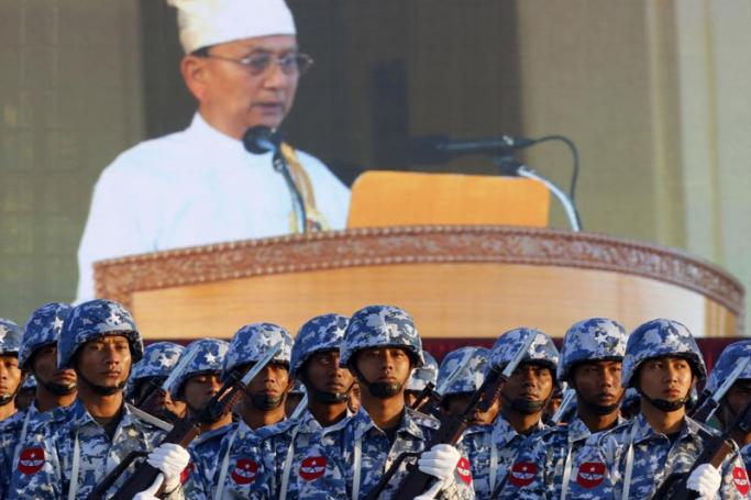 President U Thein Sein delivers a speech as seen on a background display as Myanmar Airforce soldiers participate in a ceremony to mark the 67th anniversary of Myanmar's Independence day, in Nay Pyi Taw, Myanmar, January 4, 2015. Photo: Lynn Bo Bo/EPA
