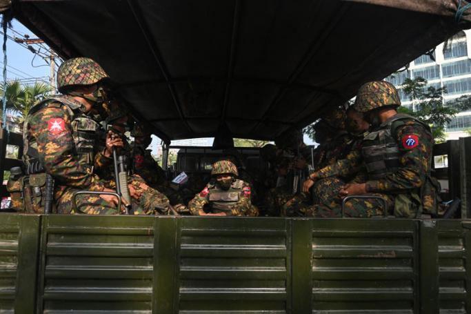 Subject: Soldiers sit in an army truck outside the Central Bank of Myanmar. Photo: AFP