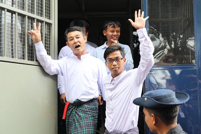 Journalists Aye Nai (L) and Lawi Weng (C) and Pyae Phone Aung (front R) leave the courthouse after appearing for a hearing in Hsipaw in Shan State on July 28, 2017. Photo: AFP
