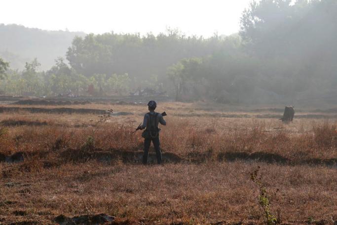 A police officer stands guard beside the road in Maungdaw township, Rakhine State, Myanmar. Photo: Nyein Chan Naing/EPA