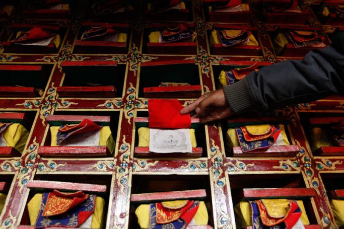 A man reaches for Tibetan scriptures in the library, at Rongbuk Monastery, the highest monastery in the world located at 5,100 meters, perched at the base of the earth's highest peak of Mt Everest, in the Tibet Autonomous Region, the People's Republic of China. Photo: EPA
