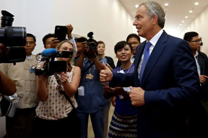 Questions have been raised about the visits of the former UK prime minister to Myanmar. Mr Tony Blair (R), former Prime Minister of United Kingdom, shows a thumb up as he walks out of the 22nd World Economic Forum in Nay Pyi Taw  2013. Photo: Nyein Chan Naing/EPA
