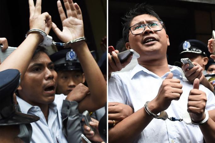 (FILES) This file combination of photos taken on September 3, 2018 shows journalists Kyaw Soe Oo (L) and Wa Lone being escorted by police after their sentencing by a court to jail in Yangon. Myanmar's Supreme Court on April 23, 2019 rejected an appeal by two Reuters journalists jailed for seven years on charges linked to their reporting on the Rohingya crisis, a defence lawyer confirmed. Photo: Ye Aung Thu/AFP
