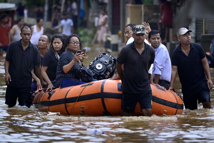 National Disaster Response Force (NDRF) personnel evacuate people from the waterlogged areas in Guwahati city, Assam, India, 14 June 2017. Torrential monsoon showers a day earlier caused flash flooding in parts of Assam and Mizoram states, particularly in Guwahati city killing at least 12 people and disturb the normal life. Photo: EPA

