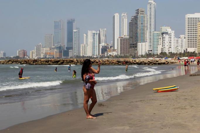 A tourist on a beach in the city of Cartagena de Indias, Colombia. Photo: EPA
