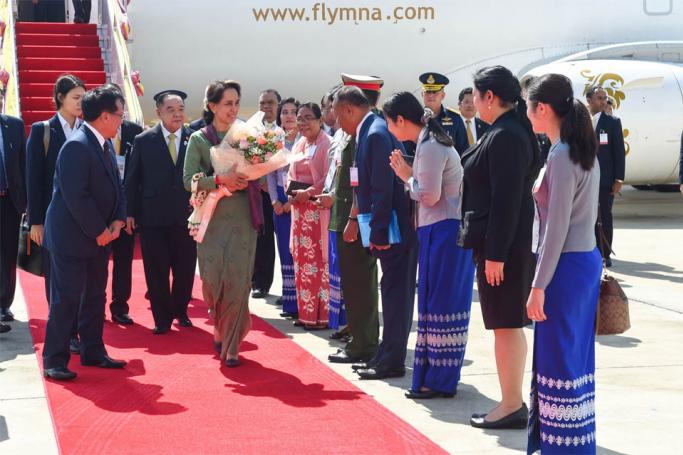This handout picture taken and released by Royal Thai Government on June 21, 2019 shows Myanmar's State Counsellor Aung San Suu Kyi (C) is being greeted upon her arrival for the 34th Association of Southeast Asian Nations (ASEAN) summit in Bangkok.Photo: Royal Thai Government 