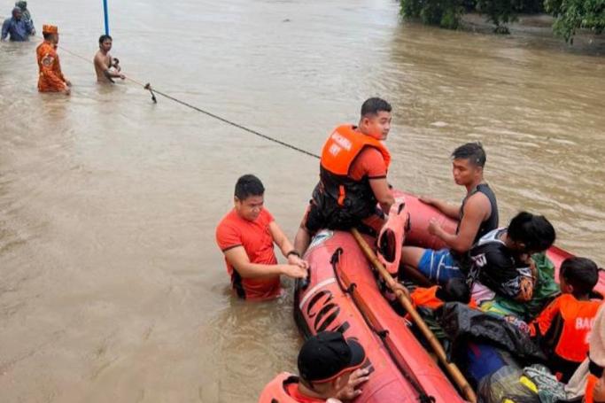 A handout photo made available by the Philippine Coast Guard (PCG) shows Coastguard personnel conducting a rescue mission in the flood-hit town of Bacarra, Ilocos Norte province, Philippines, 26 July 2023. Photo: EPA