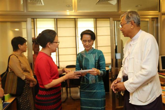 U Htin Kyaw (right) and Daw Aung San Suu Kyi (centre). Photo: DKKF
