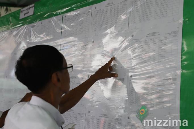 Voters check for their name in a voting list in Yangon in 2020. Photo: Thet Ko/Mizzima