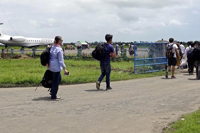 Staff from the United Nations (UN) and International Non-Governmental Organizations (INGOs) depart from Sittwe airport, in Sittwe, Rakhine State, western Myanmar, 28 August 2017. Photo: Nyunt Win/EPA
