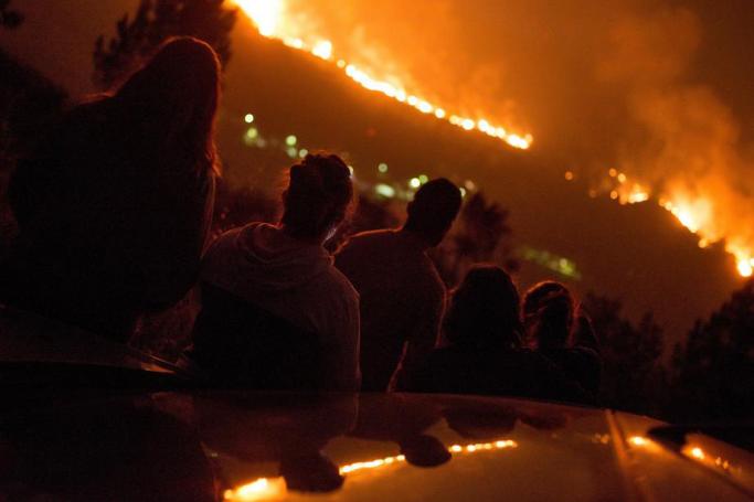 Locals watch from a distance the forest fire in Vilarino de Conso, Orense, Spain, 14 September 2020. Photo: EPA