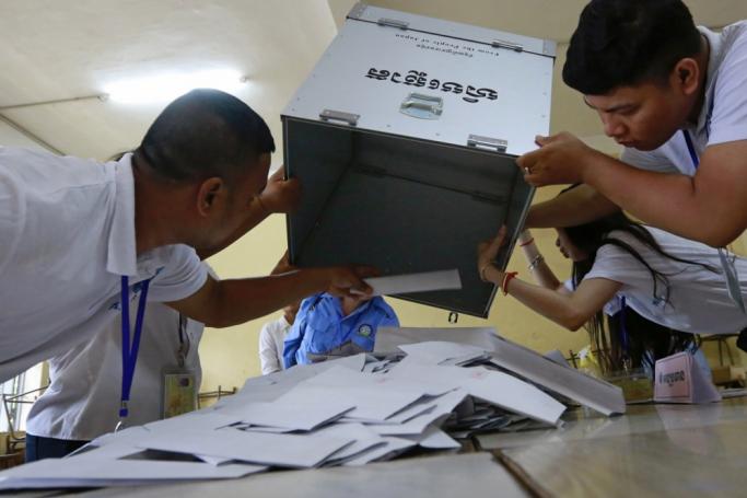 Cambodian National Election Committee officials empty a ballot box to prepare the counting of the votes at a polling station in Phnom Penh, Cambodia, 23 July 2023. Photo: EPA