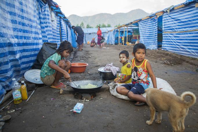 (File) Myanmar refugee children, who fled a surge in violence as the military cracks down on rebel groups, cooking at a camp in Nawphewlawl near the Myanmar-Thailand border in Kayin state. Photo: AFP