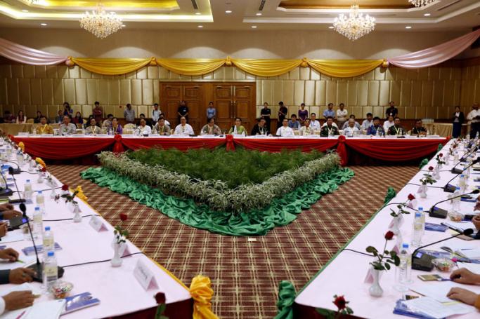 State Counsellor of Myanmar Aung San Suu Kyi (C, back) speaks to members of the Union Peace Dialogue Joint Committee during a meeting in Naypyitaw, Myanmar, 27 May 2016. Photo: Hein Htet/EPA
