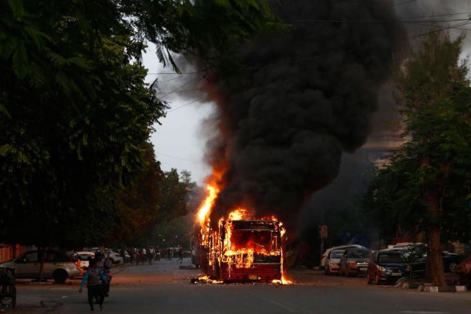 A bus on fire set by demonstrators during a protest against the Citizenship (Amendment) Bill 2019 (CAB) in New Delhi, India, 15 December 2019. Photo: EPA