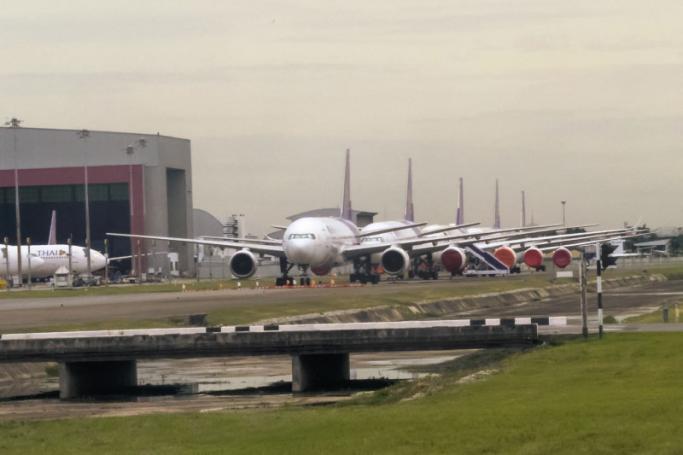 A row of grounded Thai Airways passenger aircrafts is seen at Suvarnabhumi Airport in Bangkok on August 1, 2020, as passenger numbers plummeted due to the COVID-19 coronavirus. Photo: AFP