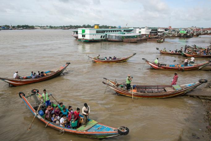 People from Dala township arriving by boat in Yangon after crossing the Yangon River. Photo: AFP