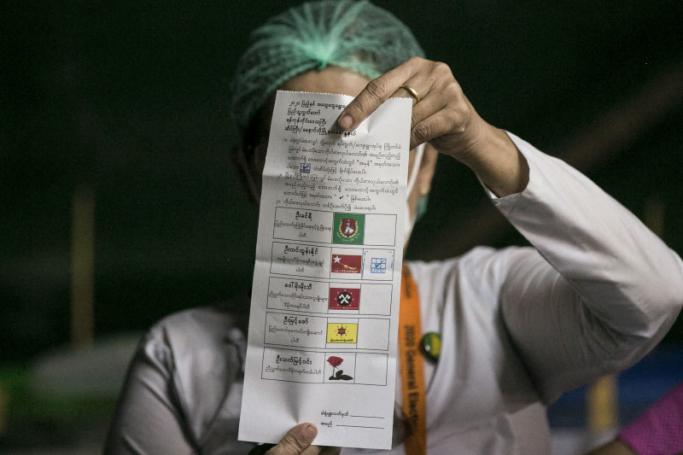 An election official counts a ballot after the polls closed at a polling station in Yangon on November 8, 2020. Photo: Sai Aung Main / AFP