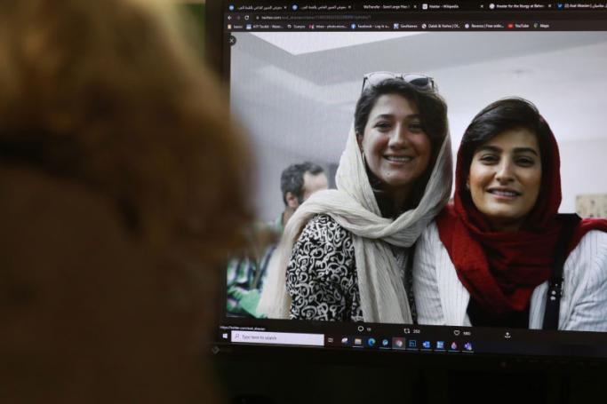A woman looks at a picture of Iranian reporters Niloufar Hamedi and Elahe Mohammadi posted on twitter, in Nicosia on November 2, 2022.  Photo: AFP