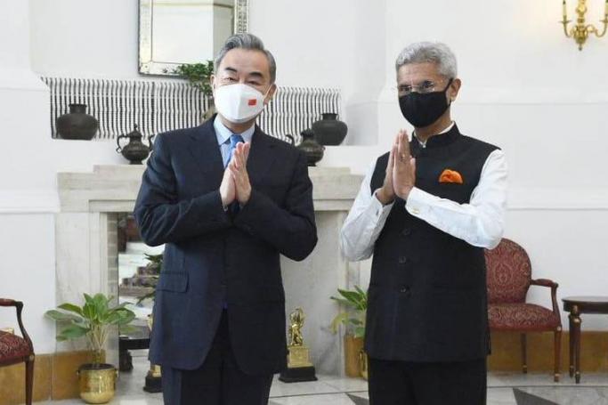 In this photo provided by Indian Foreign Minister S. Jaishankar's Twitter handle, Jaishankar and his Chinese counterpart Wang Yi greet the media before their meeting in New Delhi, India, Friday, March 25, 2022. Photo: DrSJaishankar / Twitter 