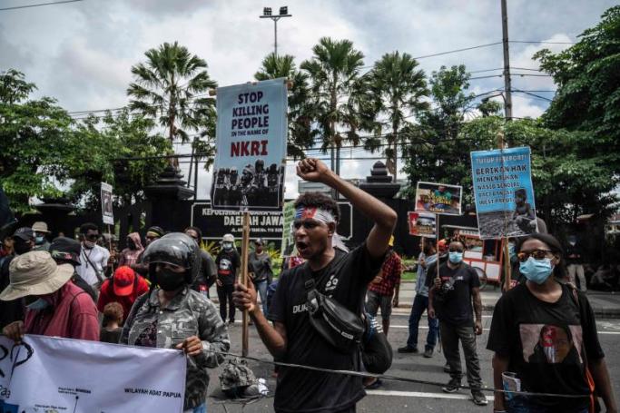Papuan students hold a protest against the Indonesian government's plan to develop new administrative areas in the country's easternmost Papua province, in Surabaya on Tuesday. Photo: AFP