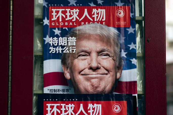 This picture taken on December 14, 2016 shows a advertisement for a magazine featuring US President-elect Donald Trump on the cover at a news stand in Shanghai. Photo: Johannes Eisele/AFP
