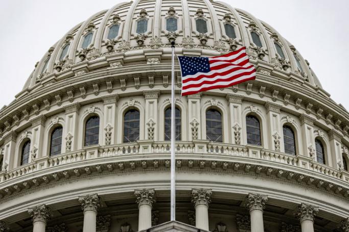 A US flag fies in front of the US Capitol building below an overcast sky on Capitol Hill in Washington, DC on April 29, 2021.  Photo:AFP