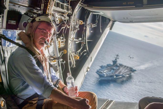 A handout photo released by the US Navy shows USS Theodore Roosevelt in the background as US Secretary of Defense Ash Carter flies in a V-22 Osprey after visiting the aircraft carrier with Malaysian Minister of Defense Hishammuddin Hussein (not pictured) in the South China Sea, 05 November 2015. Photo: EPA
