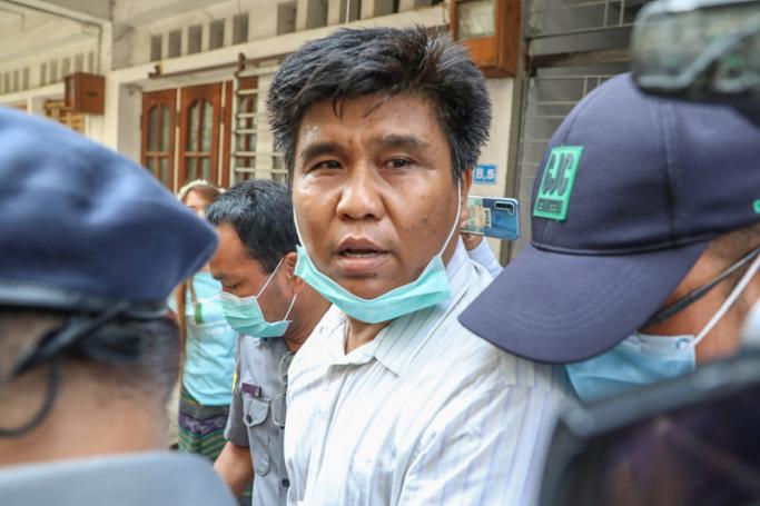 Voice of Myanmar (VOM) editor-in-chief Nay Myo Lin is escorted from his home by police to court in Mandalay on March 31, 2020. Photo: Zaw Zaw/AFP