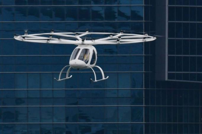 A Volocopter unmanned air taxi transport flies over Marina Bay during test flight with a safety pilot at the 26th Intelligent Transport Systems World Congress (ITSWC) in Singapore on October 22, 2019. Photo: Roslan Rahman/AFP