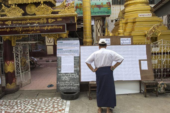 A voter checks the voters' list at a polling station in Yangon on November 3, 2018. Photo: AFP