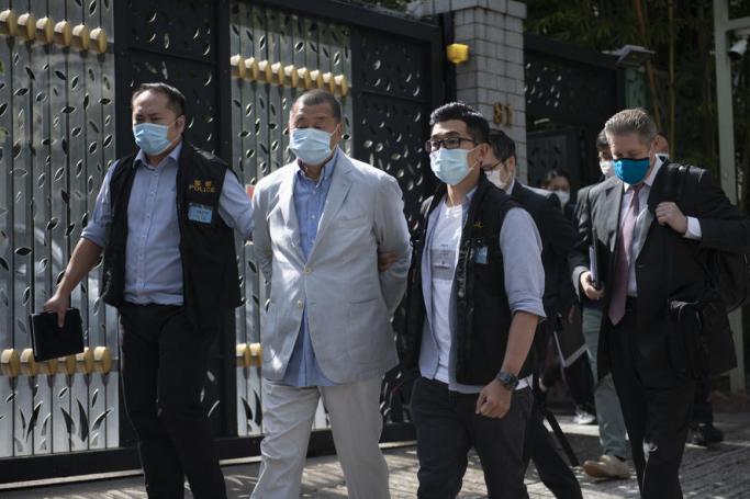 Jimmy Lai (2-R), media tycoon and founder of Apple Daily, is escorted by police after he was arrested at his home in Hong Kong, China, 10 August 2020.  Photo: EPA