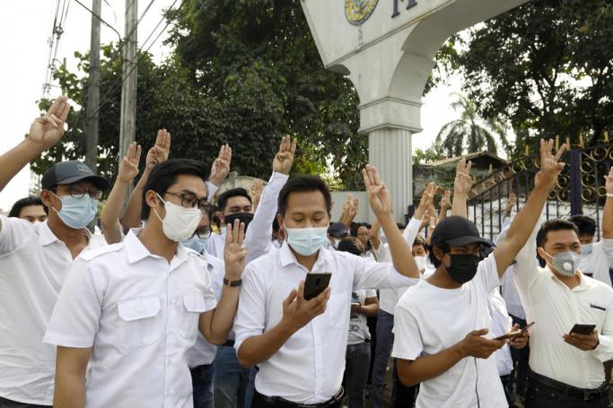 Teachers and students of Myanmar Mercantile Marine College flash three-finger salute and sing a song as they against the military coup in Yangon, Myanmar, 05 February 2021. Photo: EPA