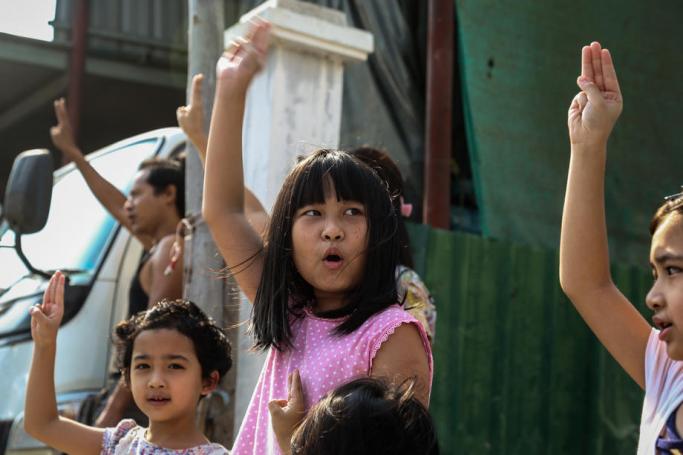 Children flash the defiant three-finger salute as demonstrators march during an anti-military coup protest in Mandalay, Myanmar. Photo: EPA
