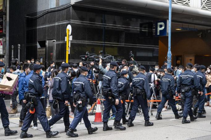  Police officers leave the pro-democracy media outlet Stand News building after the media outlet's office as been raided in Hong Kong, China. Photo: EPA