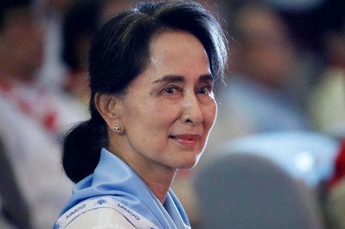 Myanmar State Counselor Aung San Suu Kyi wearing a Girl Scout uniform looks on during her swearing-in ceremony as chief of Myanmar scouts at the Yangon University Diamond Jubilee Hall in Yangon, Myanmar. Photo: EPA