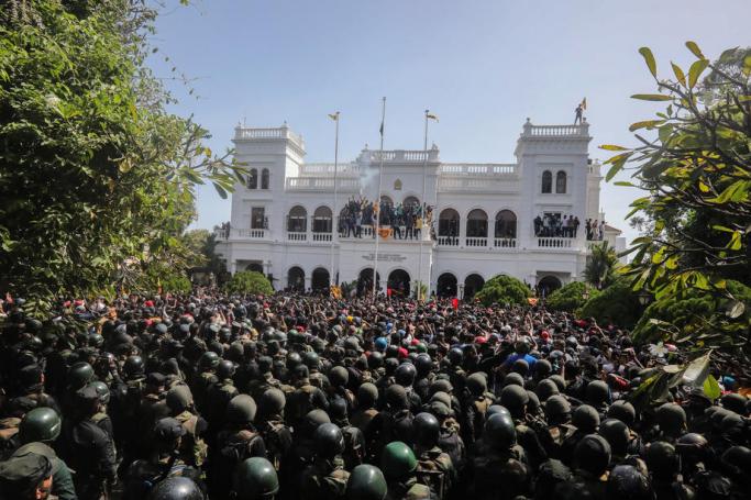 Protesters celebrate after they stormed the Prime Minister's office in Colombo, Sri Lanka, 13 July 2022. Photo: EPA