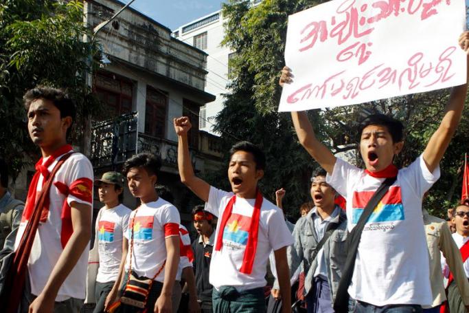 A student activist holds poster saying 'We don't want National Education Commission' as others shout slogans during the protest march in Mandalay, Myanmar, 20 January 2015. EPA/PYAE SONE AUNG
