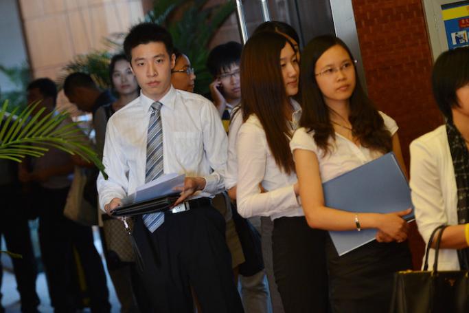 Unemployed Chinese graduates from British universities attend the LSE Beijing Career Fair as they search for jobs offered by foreign companies in Beijing.  Photo: AFP