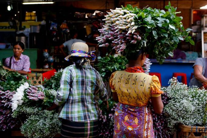Women choose flowers at Thiri Mingalar wholesale market in Yangon, Myanmar, 09 April 2015. Photo: Lynn Bo Bo/EPA
