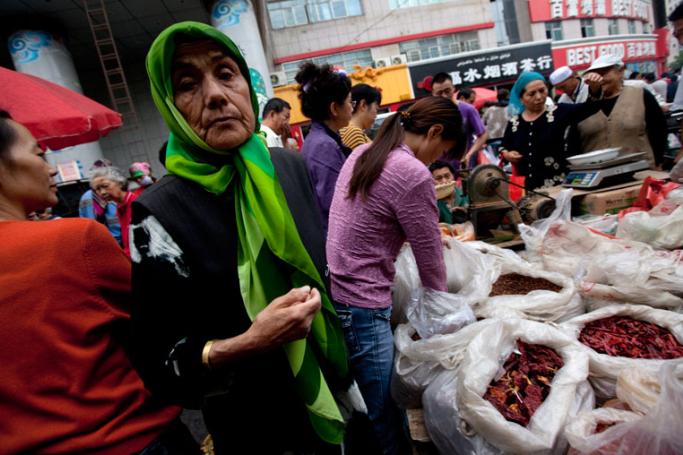 Uighurs and Han Chinese in a morning market in Urumqi, the capital of Xinjiang Uighur Autonomous region in China. Photo: How Hwee Yong/EPA
