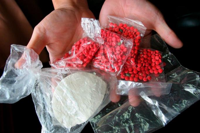 Seized drugs, heroin (white, below) and methamphetamines, called locally Ya-Ba (the pink pills, above), part of the 2005 yield at Mae Sai border crossing in northern Thailand, in the Golden Triangle. Photo: Barbara Walton/EPA
