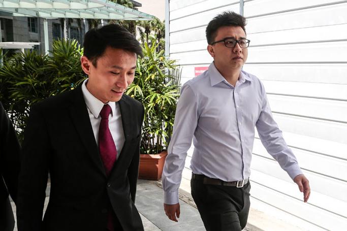 Co-founder of now-defunct socio-political website The Real Singapore (TRS), Yang Kaiheng (R) and his lawyer Choo Zheng Xi (L) walk towards the state courts for a hearing in Singapore, 28 June 2016. Photo: Wallace Woon/EPA
