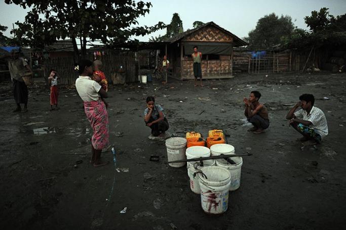 Microfinance and small business projects may sound good in theory, but do they work in practice? Residents waiting to fill plastic containers with water from a public tap in the impoverished slum quarter of Aung Mingalar on the outskirts of Yangon. Photo: AFP

