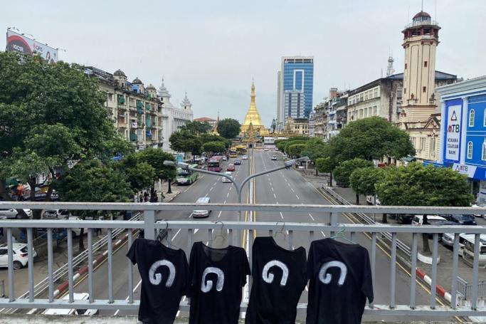 A handout photo made available by the Democratic Party for a New Society (DPNS) shows the number '8888' in Burmese digits printed on black T-shirts hanging on a bridge near the Sule pagoda (background) during a protest on the day of the anniversary of the '8888 Uprising' in downtown Yangon, Myanmar, 08 August 2023. Photo: EPA