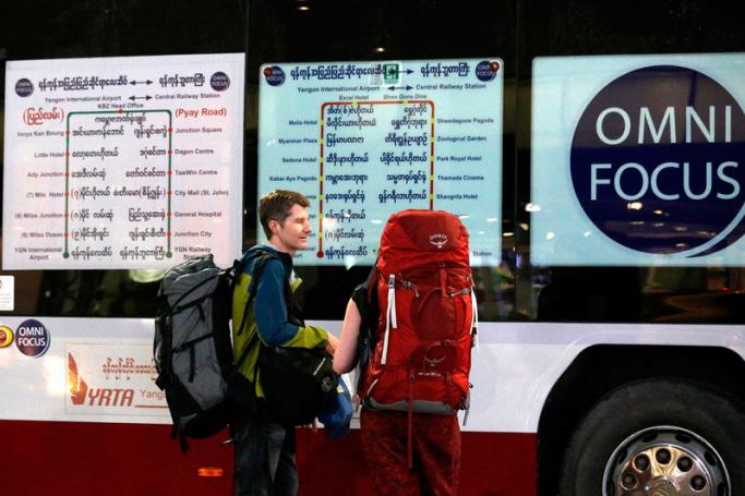 Tourist read the bus route schedule of the Omni Focus YBS Airport Shuttle 24 hour services at the Yangon International Airport in Yangon, Myanmar. Photo: Nyein Chan Naing/EPA