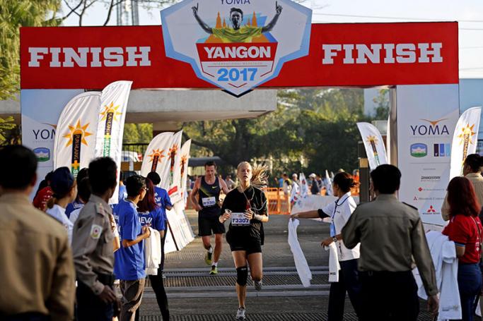 Runners pass the finish line at the end of the Yoma International Marathon 2017 in Yangon, Myanmar, 08 January 2017. Photo: Nyein Chan Naing/EPA
